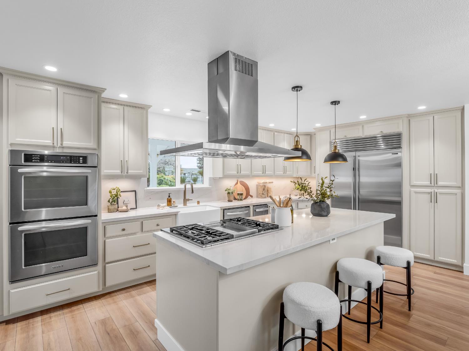 7284 West Rialto Avenue Fresno, CA 93723 - Photo 16 of 60 a kitchen with a stove a refrigerator and a dining table with wooden floor
