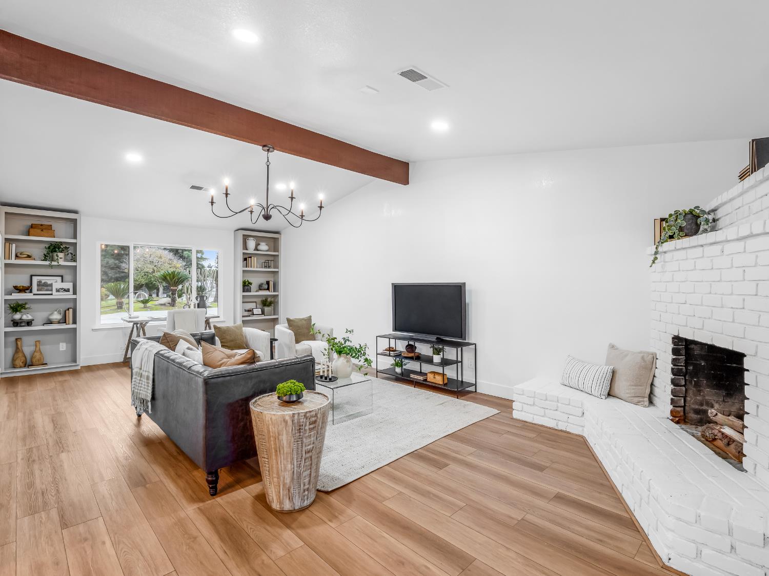 7284 West Rialto Avenue Fresno, CA 93723 - Photo 21 of 60 a living room with furniture a fireplace and a flat screen tv
