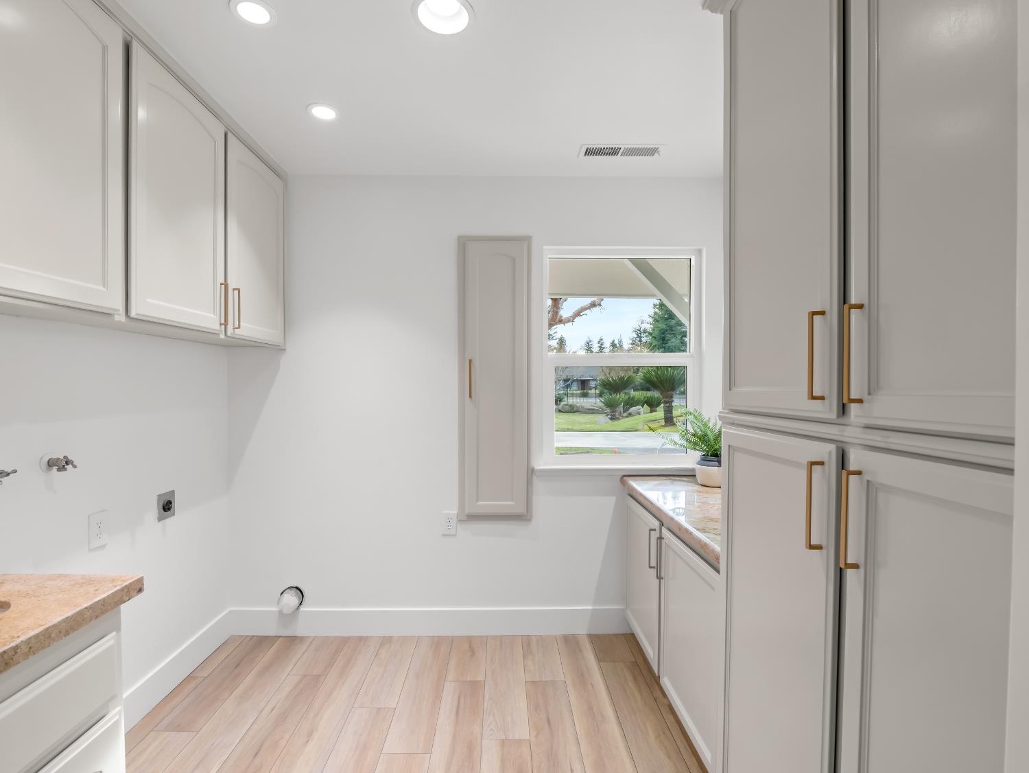 7284 West Rialto Avenue Fresno, CA 93723 - Photo 25 of 60 a view of a kitchen with wooden floor and electronic appliances