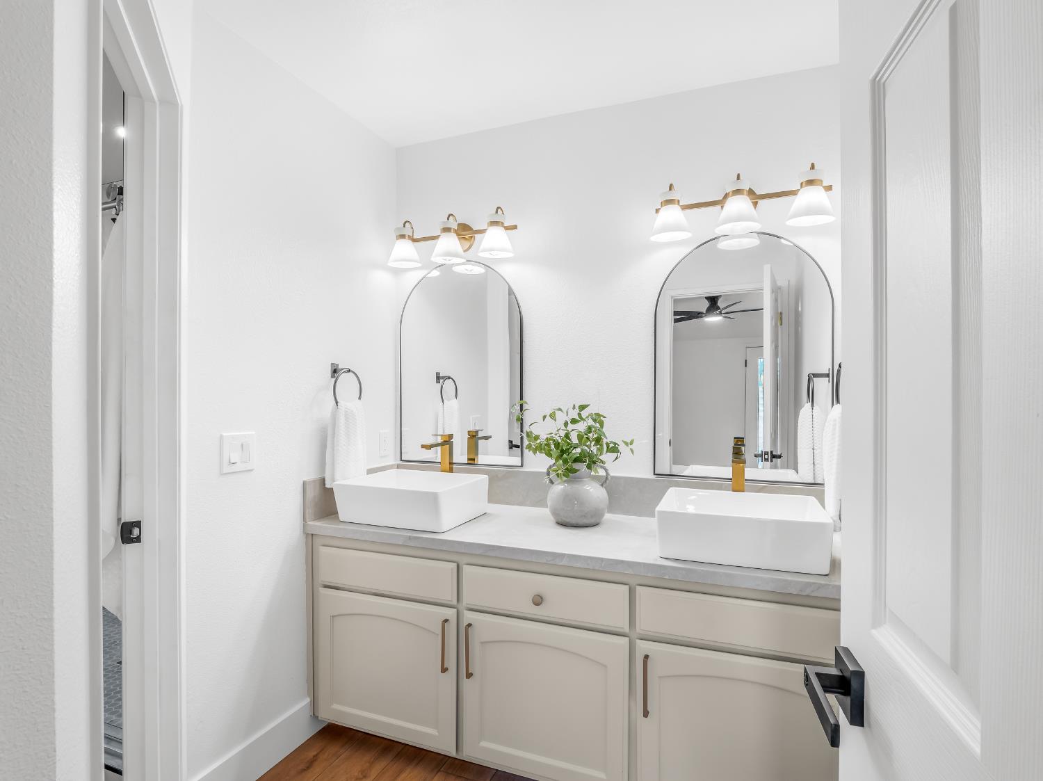 7284 West Rialto Avenue Fresno, CA 93723 - Photo 40 of 60 a bathroom with a double vanity sink and a mirror