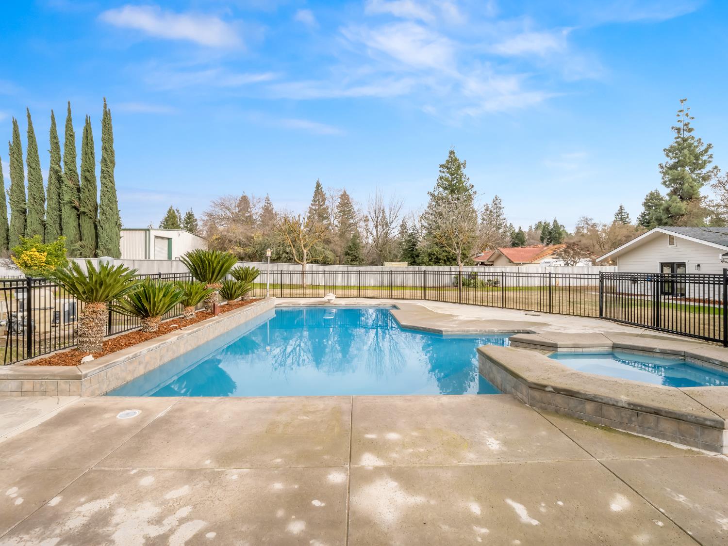 7284 West Rialto Avenue Fresno, CA 93723 - Photo 47 of 60 a view of swimming pool with outdoor seating and plants