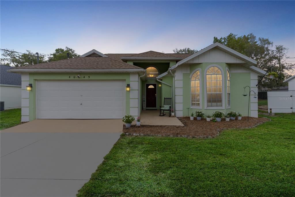 40045 Palm Street Lady Lake, FL 32159 - Photo 1 of 50 a front view of house with yard and green space