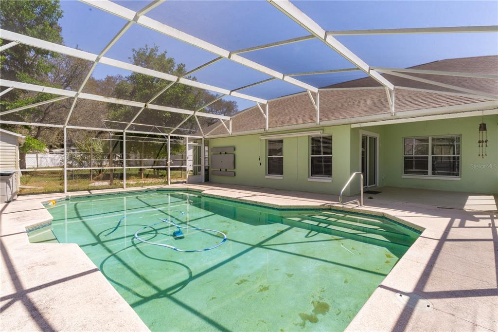 40045 Palm Street Lady Lake, FL 32159 - Photo 11 of 50 a view of a backyard with a patio and a yard