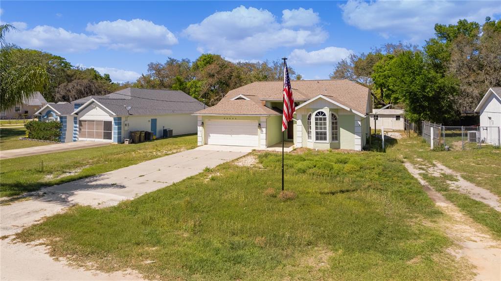 40045 Palm Street Lady Lake, FL 32159 - Photo 17 of 50 a front view of a house with a yard