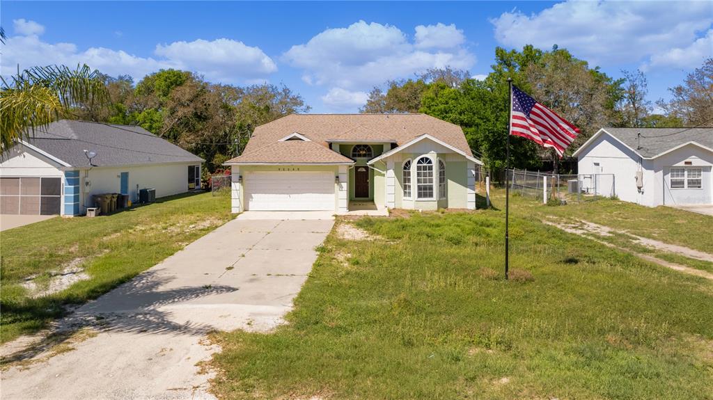 40045 Palm Street Lady Lake, FL 32159 - Photo 18 of 50 a front view of a house with a yard