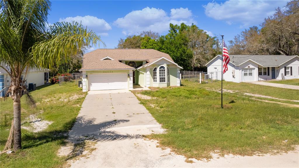 40045 Palm Street Lady Lake, FL 32159 - Photo 19 of 50 a front view of a house with a yard