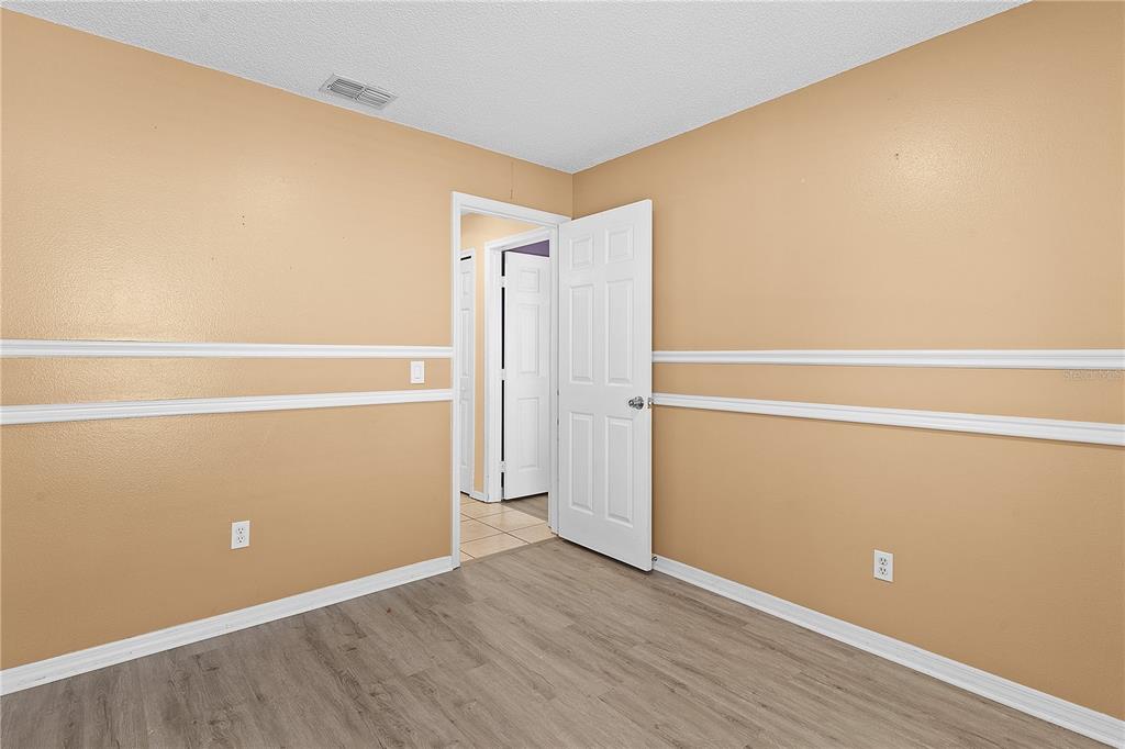 40045 Palm Street Lady Lake, FL 32159 - Photo 33 of 50 an empty room with wooden floor