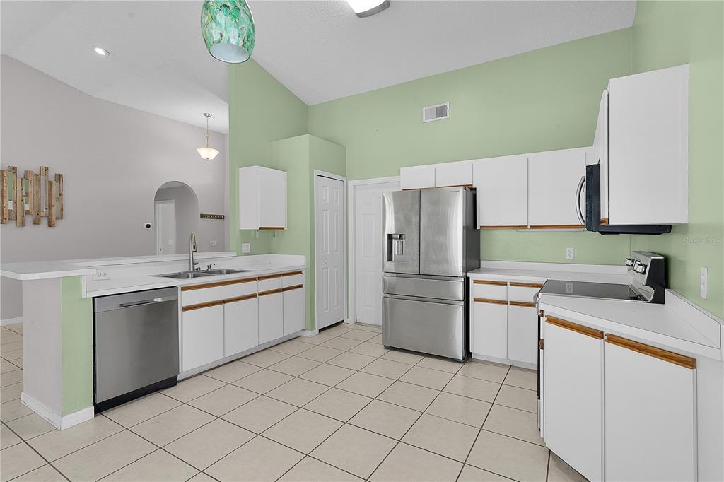 40045 Palm Street Lady Lake, FL 32159 - Photo 35 of 50 a kitchen with a sink and cabinets