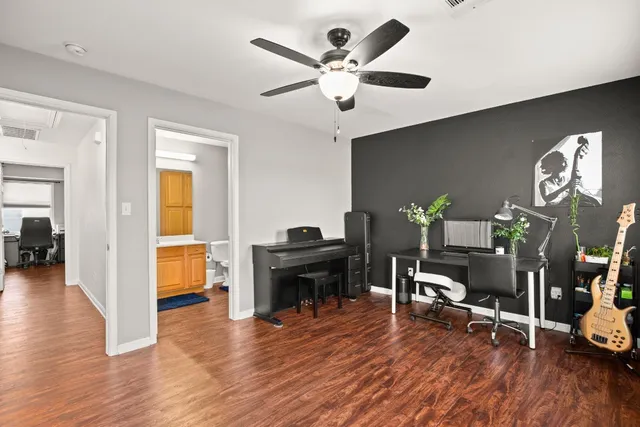 a living room with furniture and wooden floor