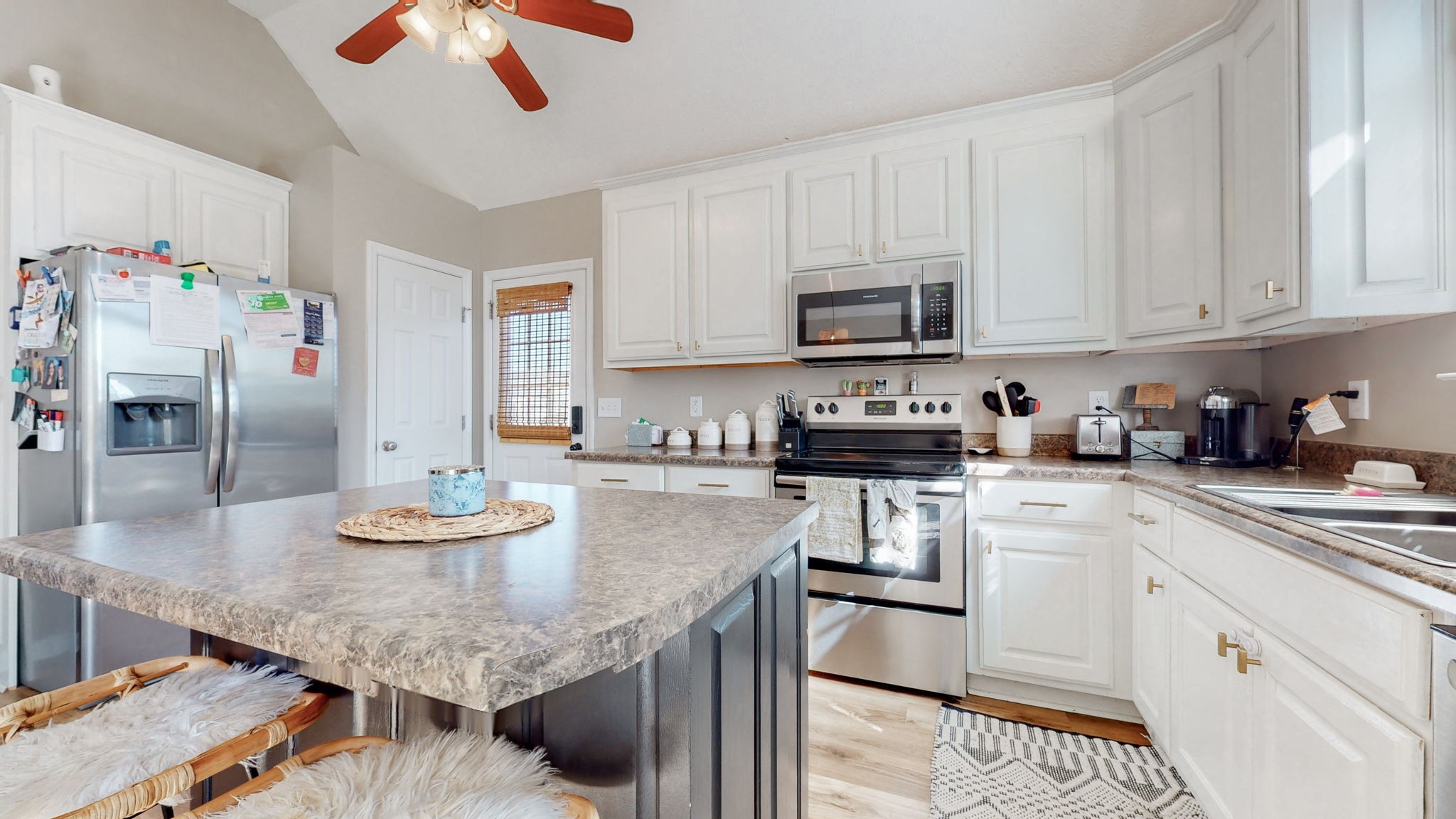 113 Wells Lee Road Elora, TN 37328 - Photo 9 of 39 a kitchen with stainless steel appliances granite countertop a sink dishwasher and cabinets with wooden floor
