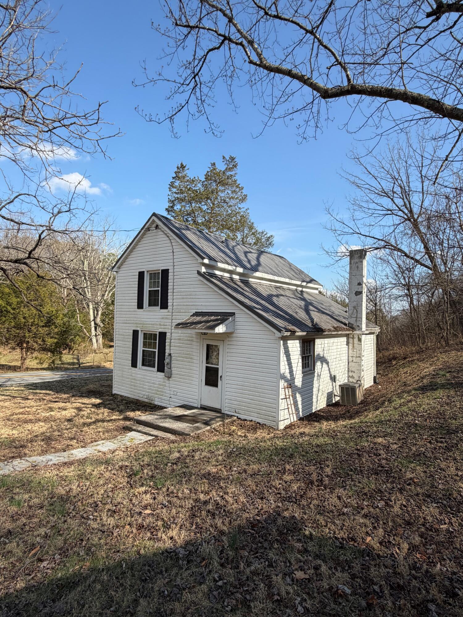 3045 Mountain Pass Road Troutville, VA 24175 - Photo 4 of 19 a white house that has tree in front of it