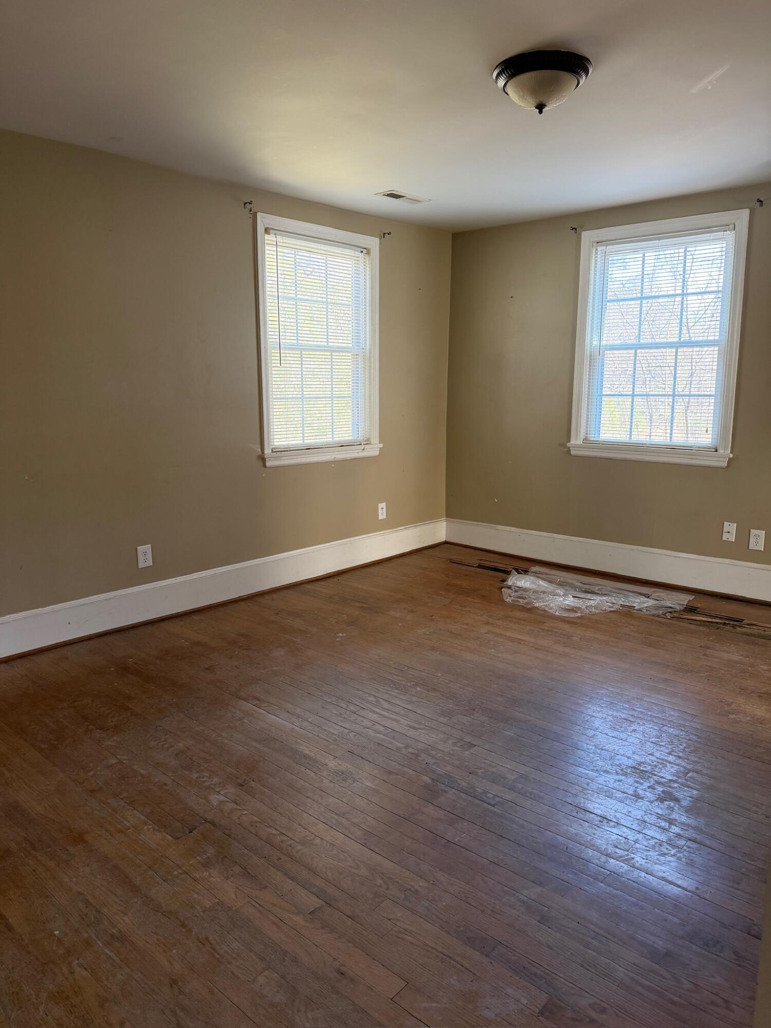 3045 Mountain Pass Road Troutville, VA 24175 - Photo 8 of 19 an empty room with wooden floor and windows