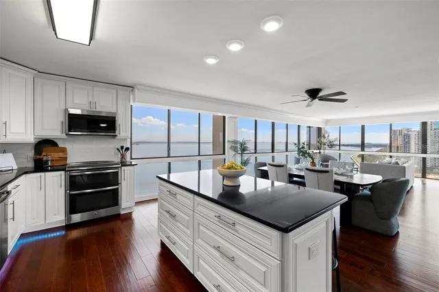 a kitchen with a sink dishwasher a stove and a refrigerator with wooden floor