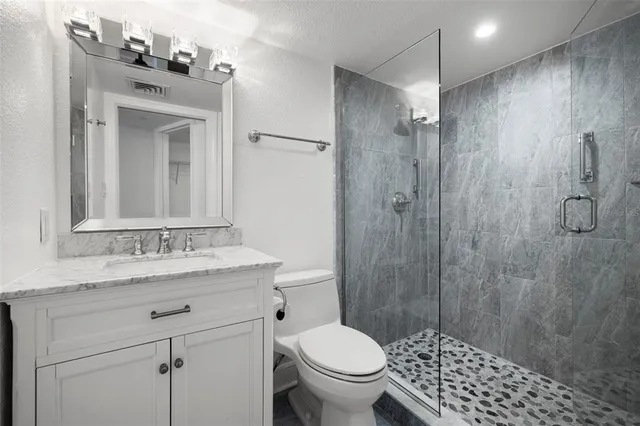 a bathroom with a sink toilet and shower