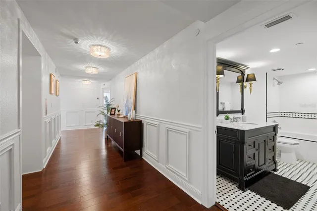 a bathroom with a sink a toilet and mirror