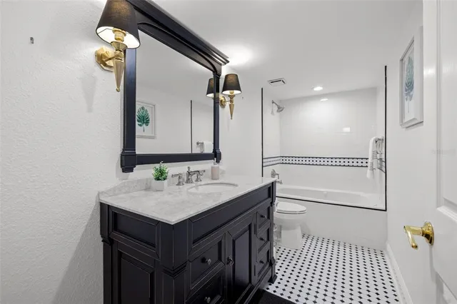 a bathroom with a sink a toilet and mirror