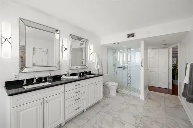 a bathroom with double sink and a mirror