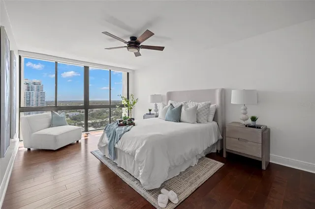 a spacious bedroom with a bed and a large window