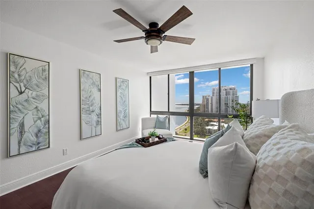 a bed room with a bed and a large window