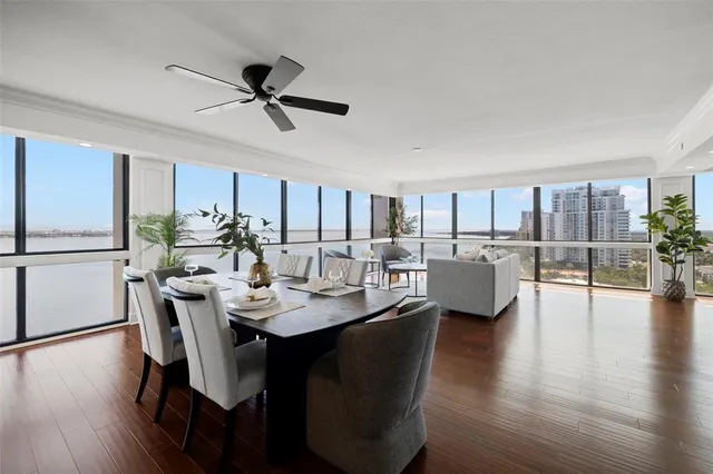 a dining room with furniture a window and wooden floor