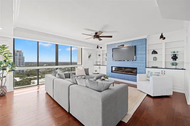 a living room with furniture a fireplace and a flat screen tv