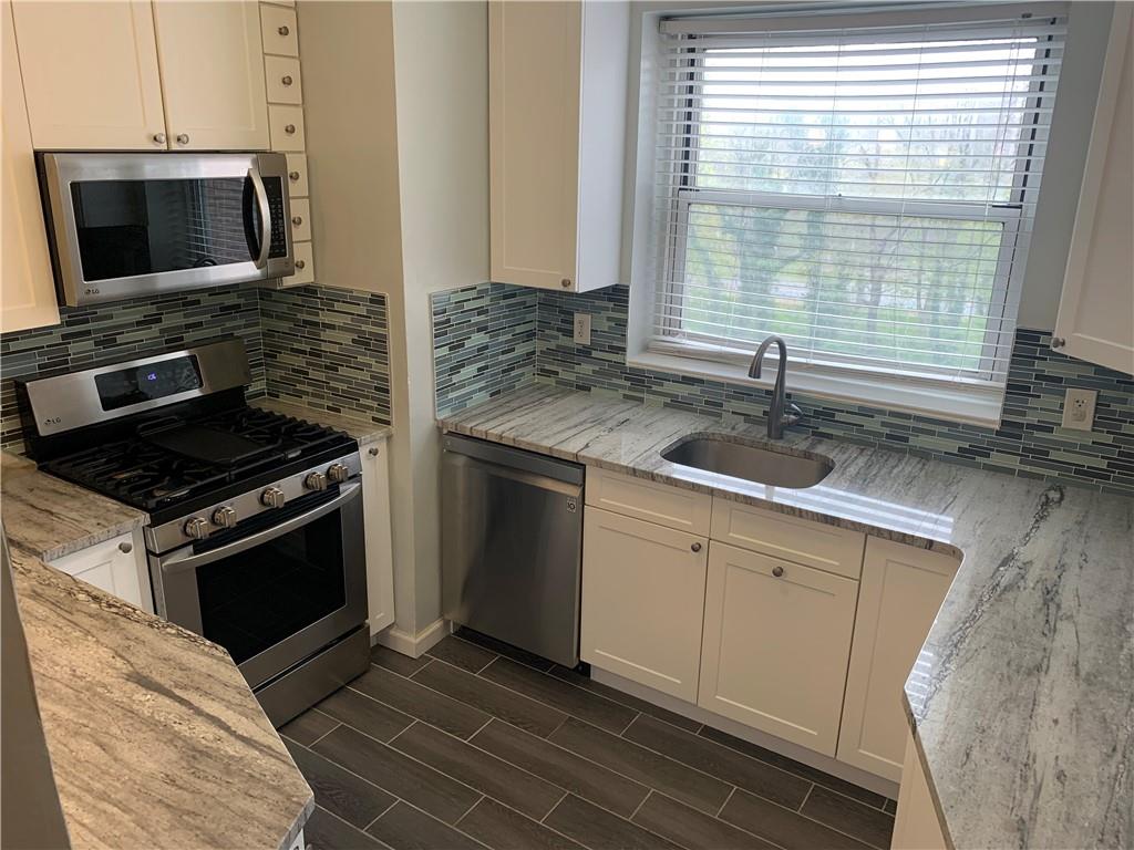 804 Bronx River Road, Unit 4D Bronxville, NY 10708 - Photo 1 of 1 a kitchen with a stove and a microwave