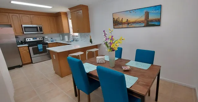 a dining room with furniture a kitchen island a stove a kitchen island a dining table and chairs