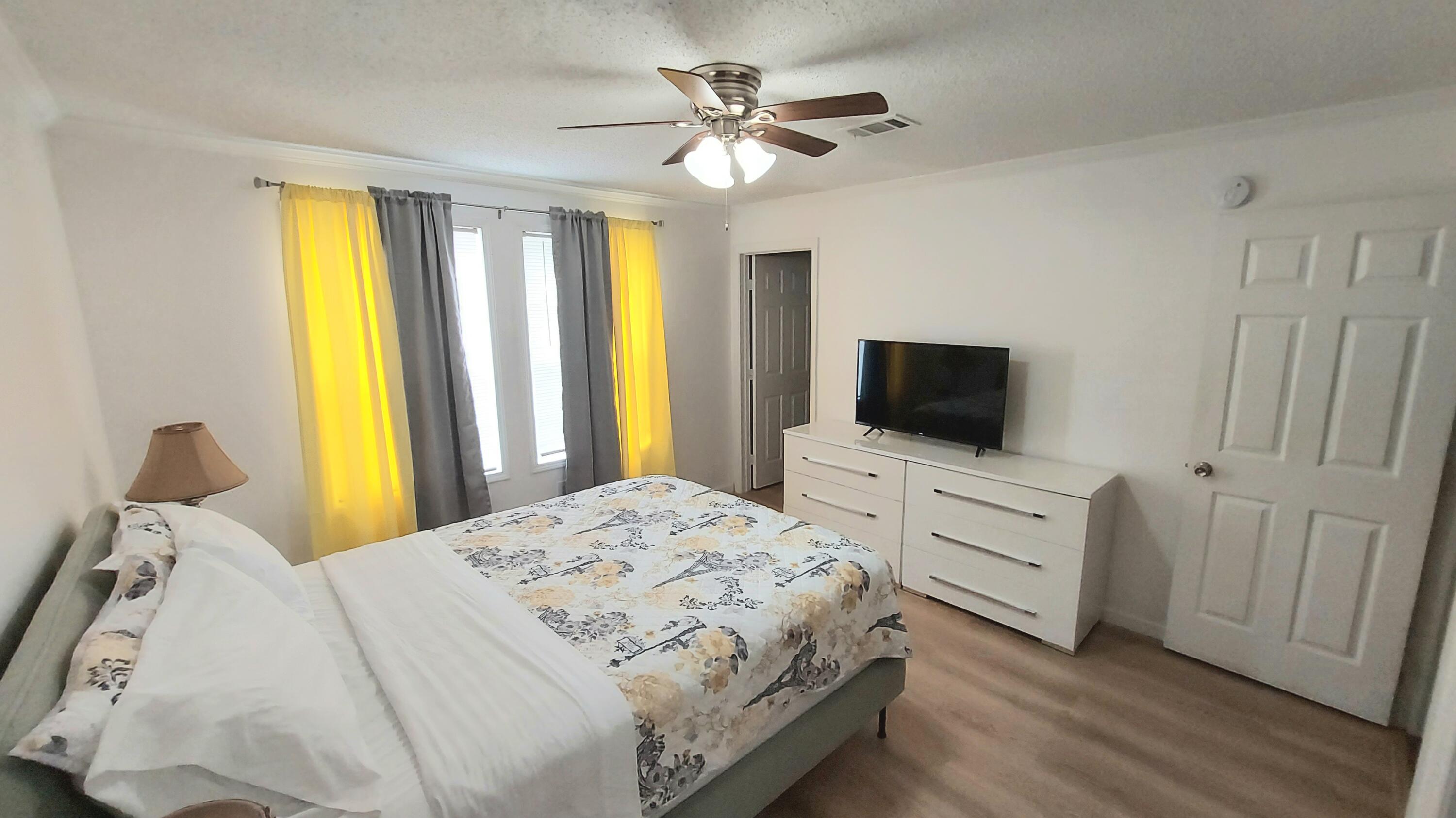 1401 West 9th Street Riviera Beach, FL 33404 - Photo 6 of 17 a bedroom with a bed and a flat screen tv