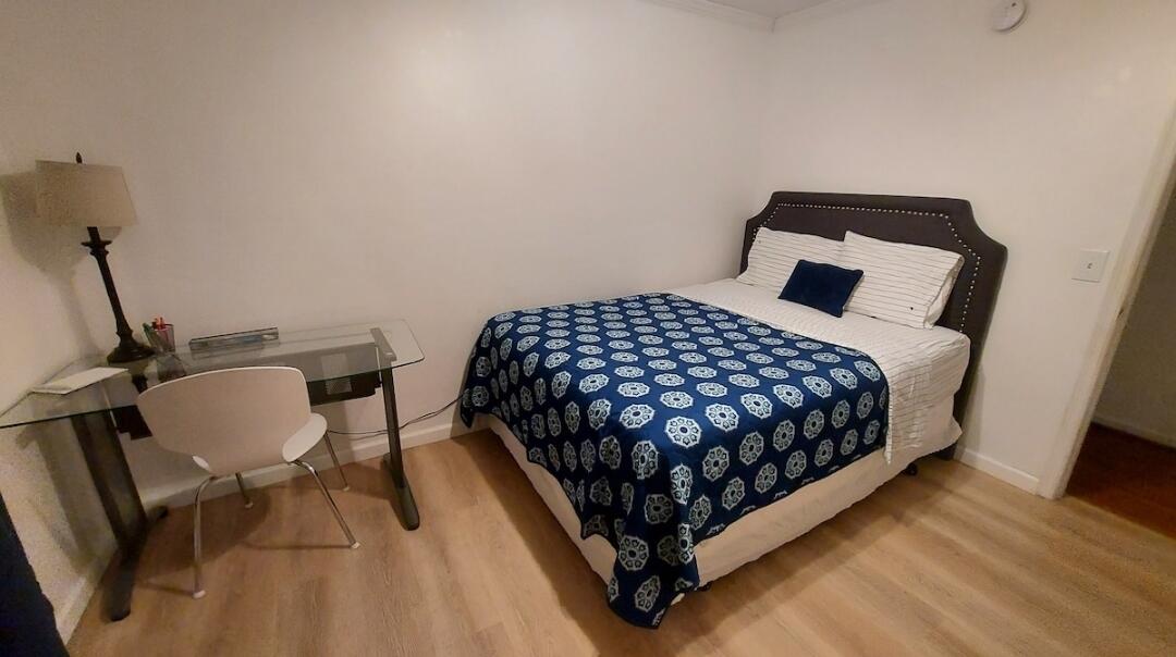 1401 West 9th Street Riviera Beach, FL 33404 - Photo 9 of 17 a bedroom with a bed window and chair