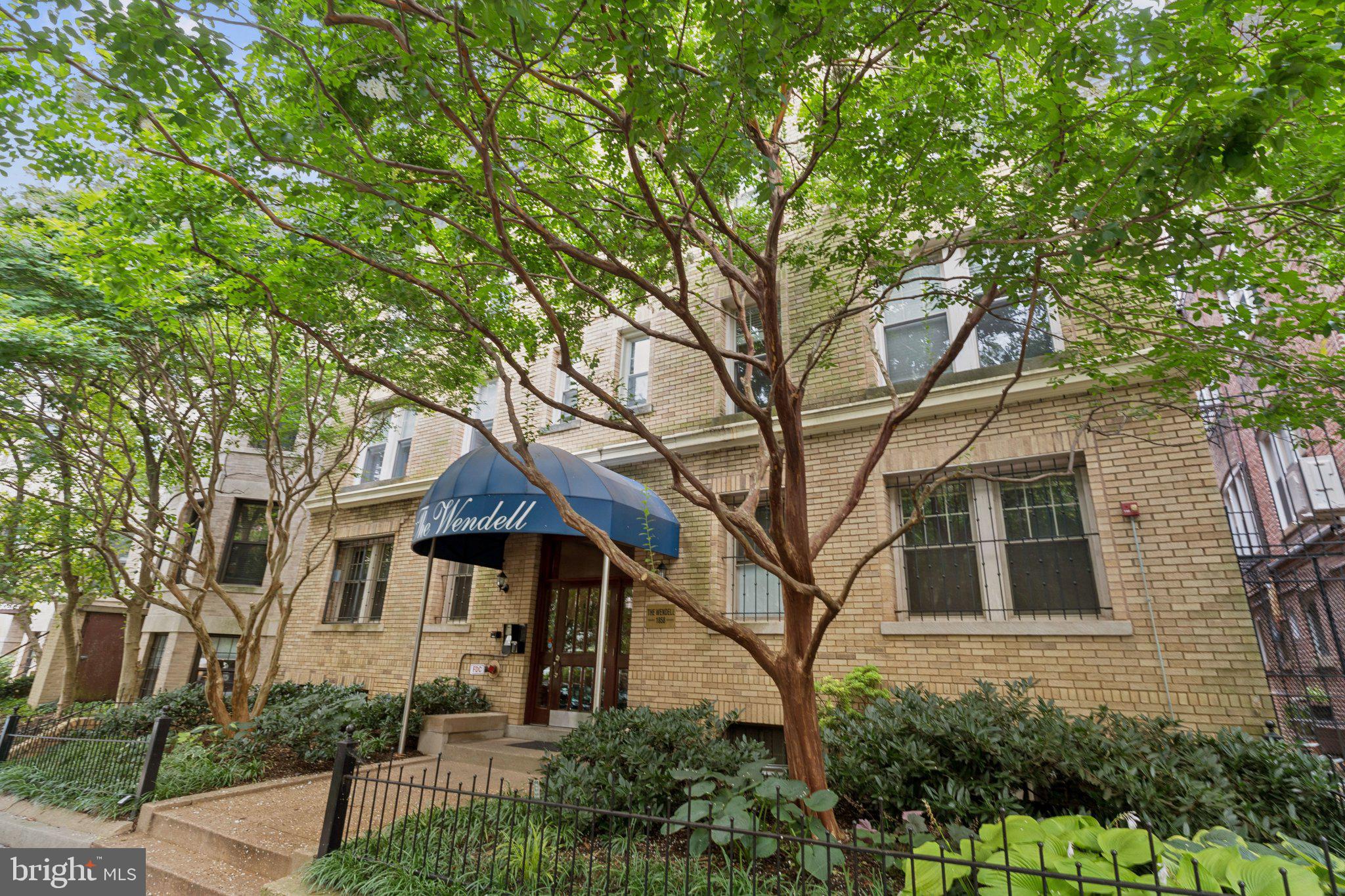1858 California Street Northwest, Unit 5 Washington, DC 20009 - Photo 25 of 28 Charming brick building with lush greenery.