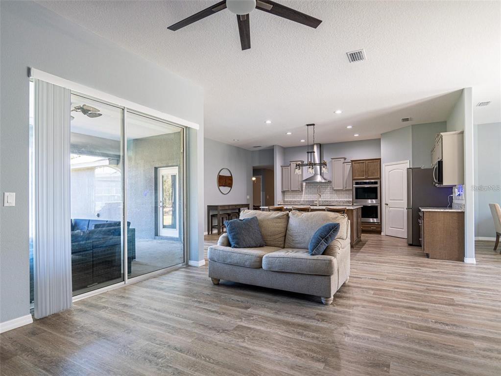 10688 Southwest 129th Terrace Road Dunnellon, FL 34432 - Photo 12 of 35 a living room with furniture and kitchen view