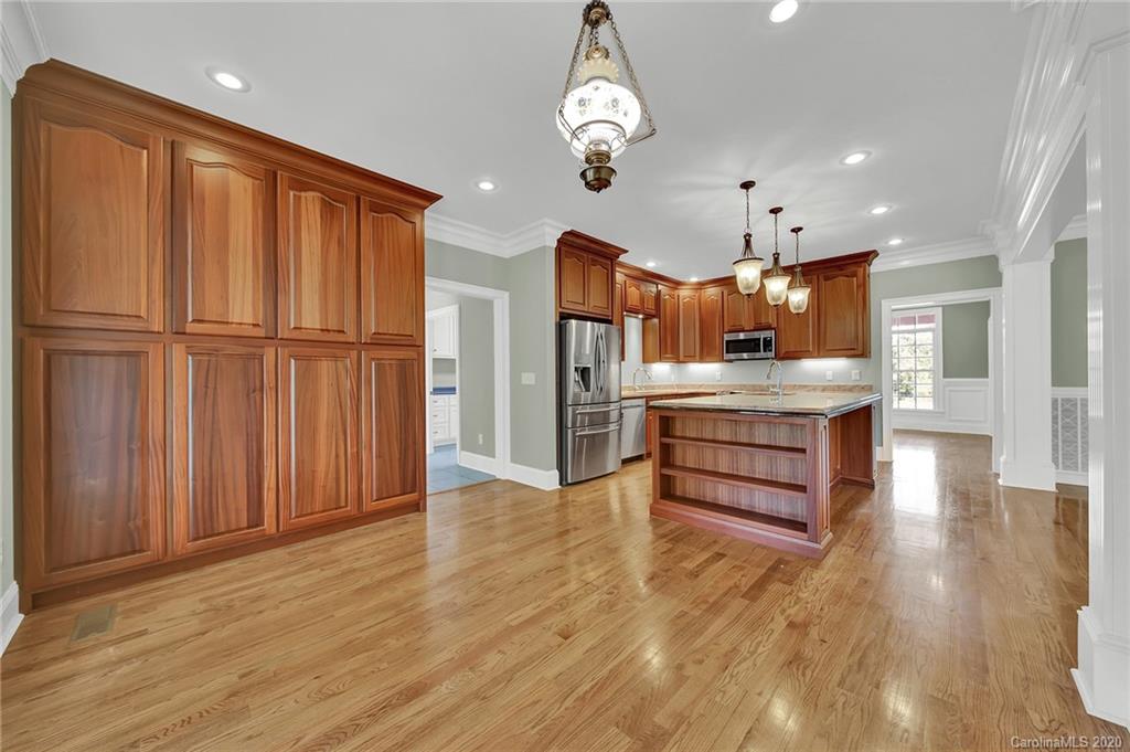 3705 Mining Road Kershaw, SC 29067 - Photo 12 of 47 a large kitchen with stainless steel appliances granite countertop a refrigerator a stove and a wooden floors