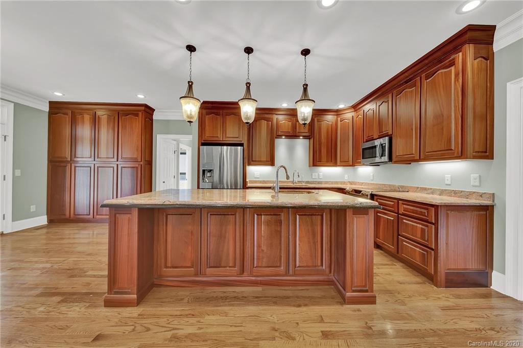 3705 Mining Road Kershaw, SC 29067 - Photo 7 of 47 a kitchen with stainless steel appliances granite countertop a stove a sink dishwasher and a wooden cabinets