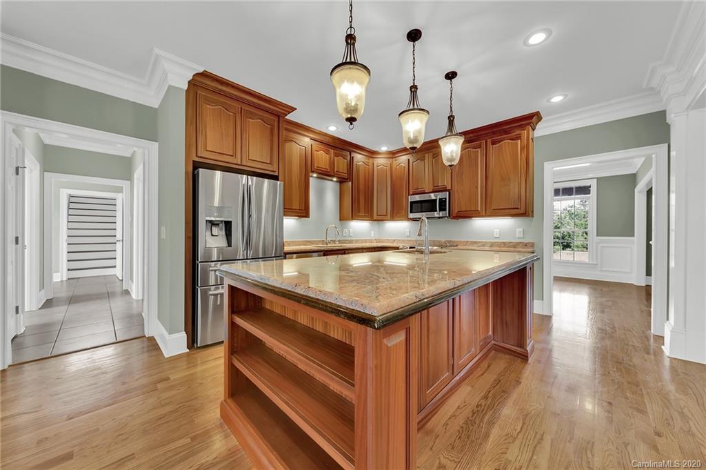 3705 Mining Road Kershaw, SC 29067 - Photo 8 of 47 a kitchen with kitchen island granite countertop a stove and a wooden floors