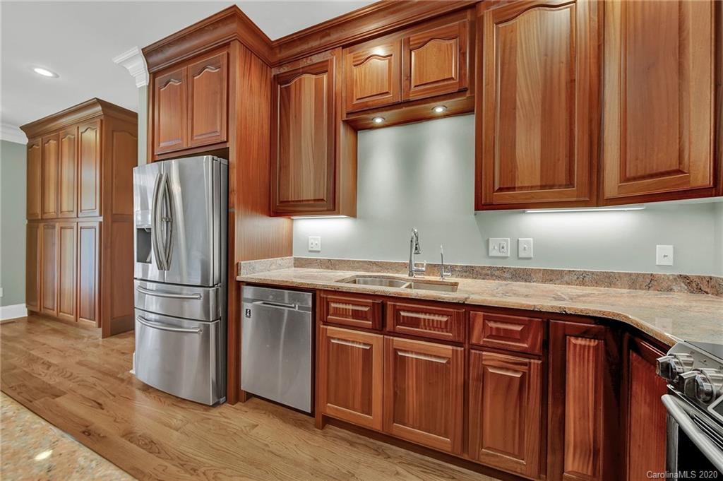 3705 Mining Road Kershaw, SC 29067 - Photo 10 of 47 a kitchen with granite countertop wooden cabinets a refrigerator and a sink