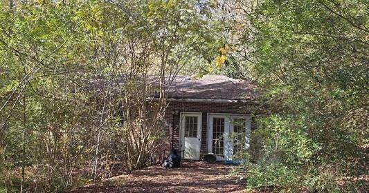 2900 Lay Springs Road Gadsden, AL 35904 - Photo 5 of 6 a front view of a house with a tree