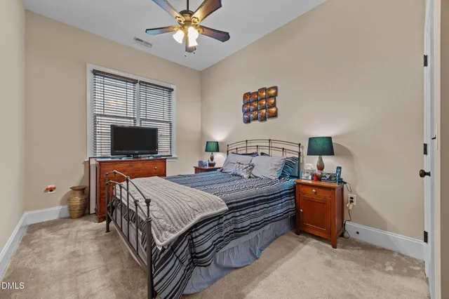 a bedroom with a bed and a tv