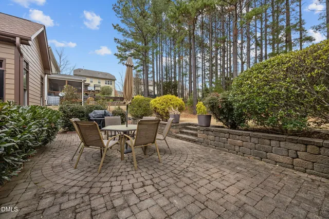 a living room with furniture a fireplace and a floor to ceiling window