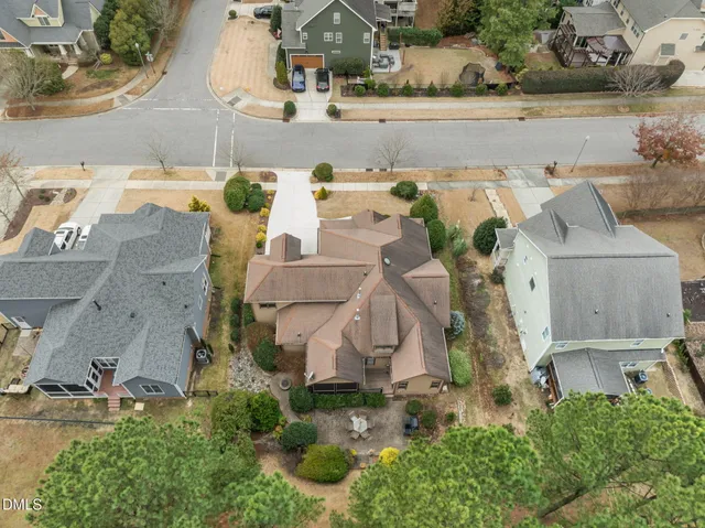 a view of a yard with plants and trees beside of it