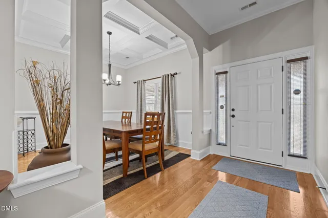 a front view of a house with yard and parking