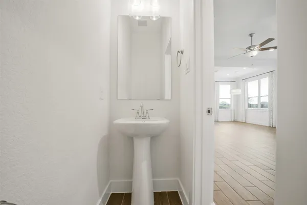 a bathroom with a tub shower and a sink