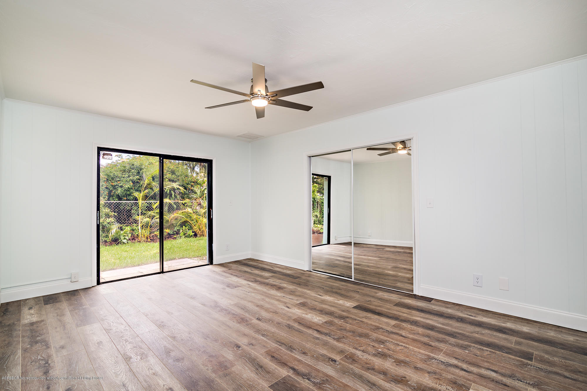 1870 Travis Road West Palm Beach, FL 33406 - Photo 15 of 35 a view of an empty room with a window and wooden floor