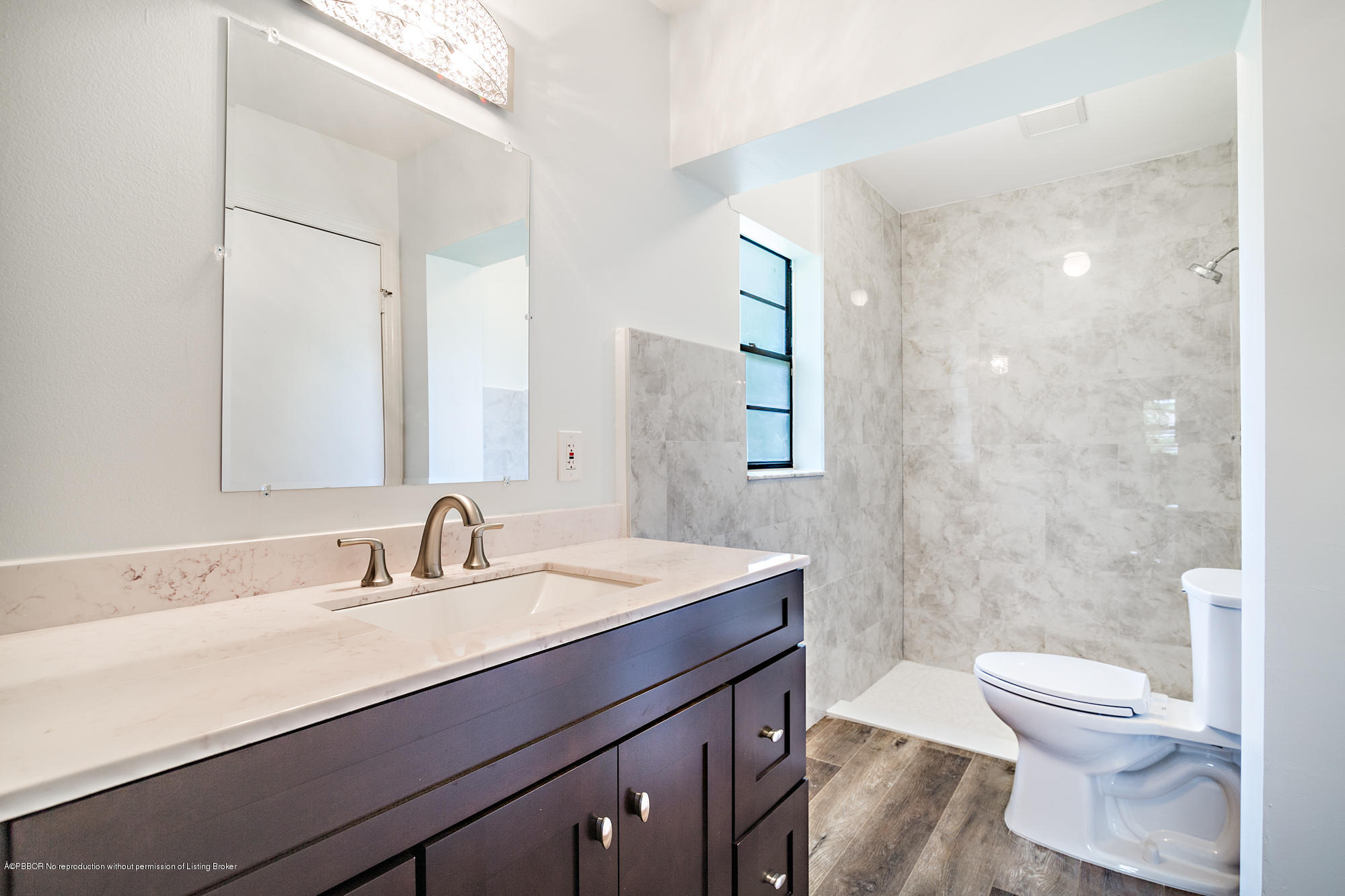 1870 Travis Road West Palm Beach, FL 33406 - Photo 20 of 35 a bathroom with a sink a toilet a mirror and shower