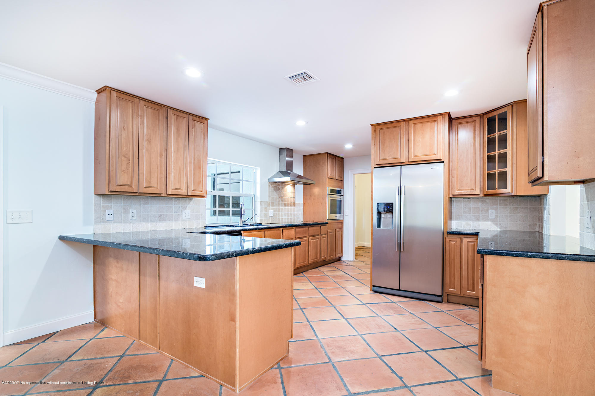 1870 Travis Road West Palm Beach, FL 33406 - Photo 5 of 35 a kitchen with stainless steel appliances granite countertop a refrigerator sink and cabinets