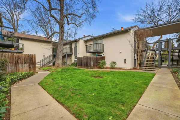 a backyard of a house with table and chairs