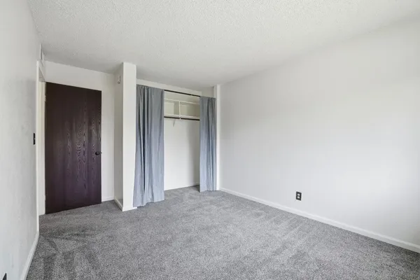an empty room with closet area