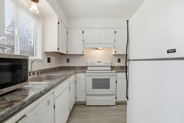 a bathroom with a sink a toilet and a large mirror