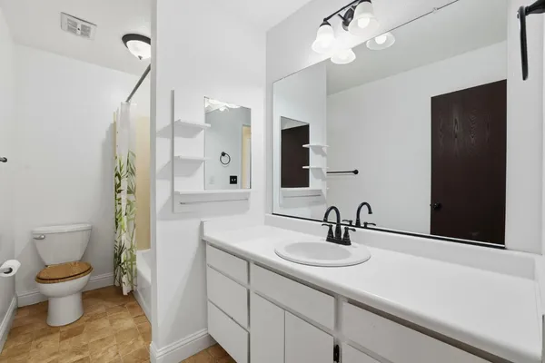 a view of a swimming pool with a patio and a yard