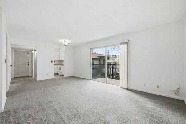 an empty room with a kitchen and a sink