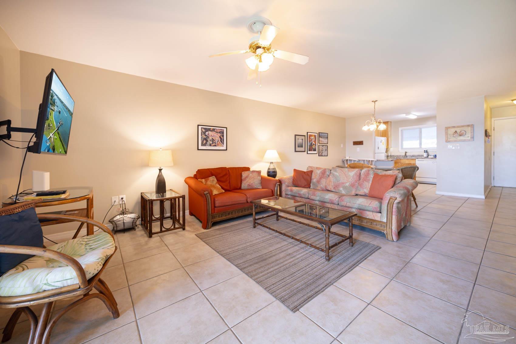 16470 Perdido Key Drive, Unit B13 Perdido Key, FL 32507 - Photo 12 of 30 a living room with furniture and a chandelier
